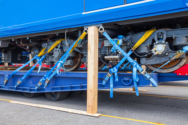 CERTEX Lifting's blue ratchet webbing tie down used on a semi-trailer to safely and efficiently secure its cargo.